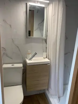 a bathroom with a sink and a toilet and a mirror at Studette Cosy in Nice