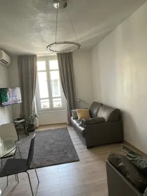 a living room with a couch and a table at Apartment on Dante street next to the sea in Nice