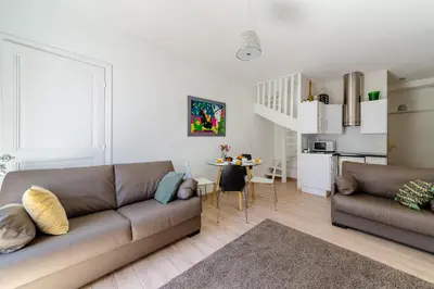 a living room with a couch and a table at Apartment on Dante street next to the sea in Nice