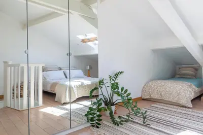 a bedroom with two beds and a glass wall at Apartment on Dante street next to the sea in Nice