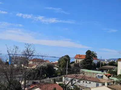 a view of a city with houses and the ocean at T2 Vue Mer avec Grande Terrasse & Parking 4 min Plage - SpiritofFamily06 in Cagnes-sur-Mer