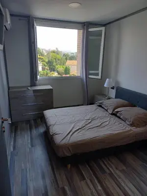 a bedroom with a large bed and a window at Nice Signature Caucade in Nice