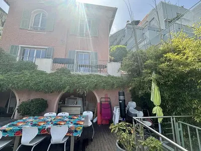 a patio with a table and chairs in front of a building at Nice Signature Bellet in Nice