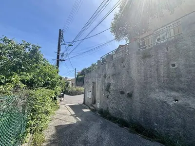 an alley with a stone wall next to a street at Nice Signature Bellet in Nice