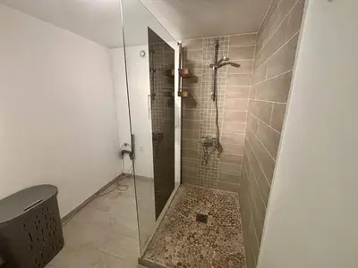 a shower with a glass door in a bathroom at Nice Signature Bellet in Nice