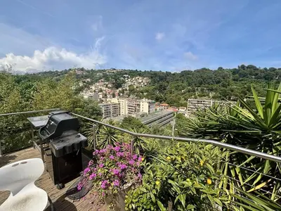 a balcony with flowers and a view of a city at Nice Signature Bellet in Nice