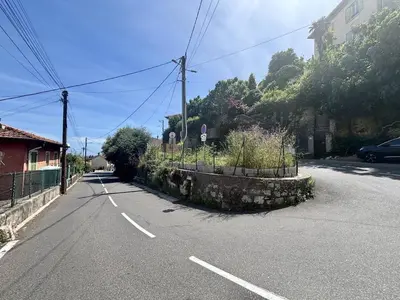 an empty street with a stone wall on the side of the road at Nice Signature Bellet in Nice
