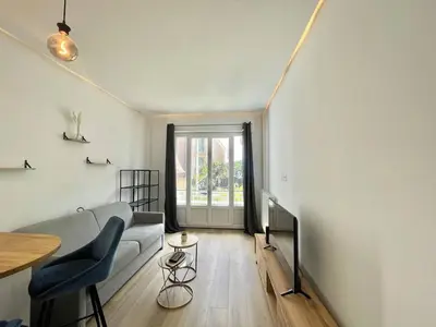a living room with a couch and a table at Nice Signature Andrioli in Nice