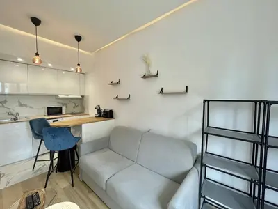 a living room with a couch and a desk at Nice Signature Andrioli in Nice