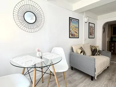 a living room with a table and a couch at A OT Cocon d Augustin Old Town Nice Center in Nice
