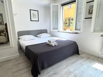 a bedroom with a bed with a teddy bear on it at A OT Cocon d Augustin Old Town Nice Center in Nice