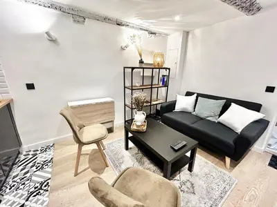 a bedroom with a white bed with a towel on it at B OT Le Cocon de la Prefecture - Old Town in Nice