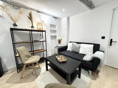 a room with a table and two chairs and a television at B OT Le Cocon de la Prefecture - Old Town in Nice