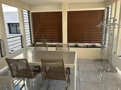 a white table and chairs on a balcony with windows at Appartement neuf T2 calme avec terrasse - Proche Marché Liberation in Nice