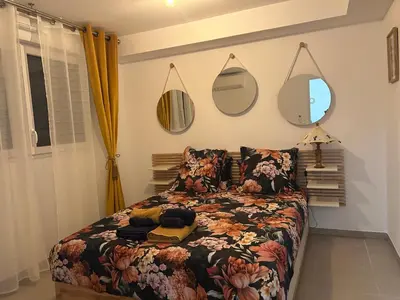 a bedroom with a bed and mirrors on the wall at Appartement neuf T2 calme avec terrasse - Proche Marché Liberation in Nice