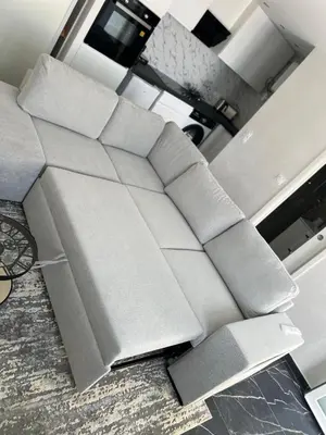 a couch sitting in a living room at Amoremio studio Saint Laurent du Var in Saint-Laurent-du-Var