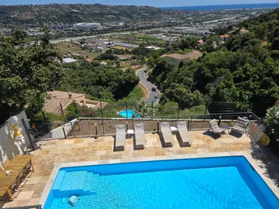 a swimming pool with a view of a city at Amoremio studio Saint Laurent du Var in Saint-Laurent-du-Var