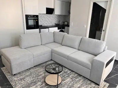 a living room with a couch and a table at Amoremio studio Saint Laurent du Var in Saint-Laurent-du-Var