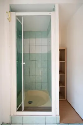 a bath tub in a bathroom with a glass door at Guest House La Niçoise in Nice