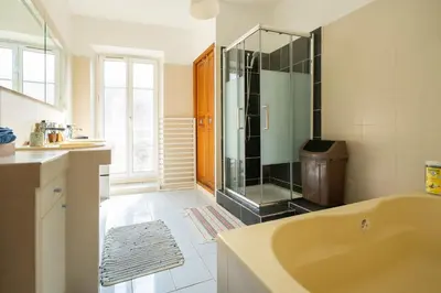 a bathroom with a tub and a glass shower at Guest House La Niçoise in Nice