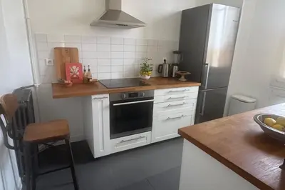 a kitchen with a stove and a refrigerator at Top Floor Central Steps from the sea in Nice