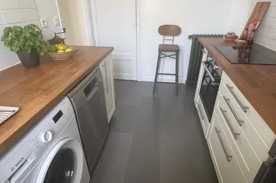 a kitchen with a washing machine in a kitchen at Top Floor Central Steps from the sea in Nice