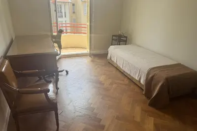 a bedroom with a bed and a desk and a chair at Top Floor Central Steps from the sea in Nice