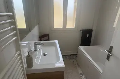 a white bathroom with a sink and a tub at Top Floor Central Steps from the sea in Nice