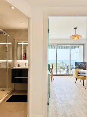 a kitchen and living room with a view of the ocean at Le Milord - Easy Home Booking in Nice