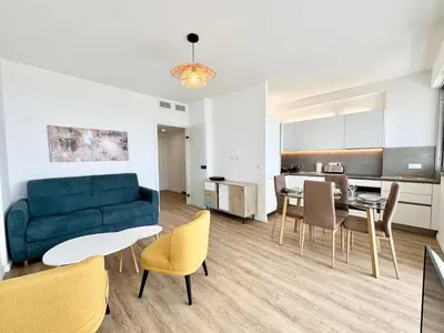 a living room with a couch and a table and chairs at Le Milord - Easy Home Booking in Nice