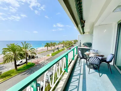 a balcony with a table and chairs and a view of the ocean at Le Milord - Easy Home Booking in Nice