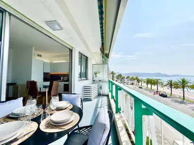 a balcony with a dining table with a view of the ocean at Le Milord - Easy Home Booking in Nice