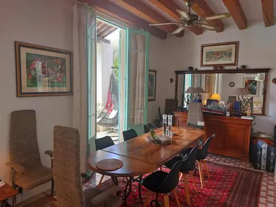 a dining room with a wooden table and chairs at Villa, Villefranche-sur-mer, Pool, Tennis Court, in Villefranche-sur-Mer