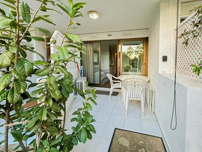 a patio with a table and chairs and plants at Ange Gardien - AC, Parking, Piscine in Villefranche-sur-Mer