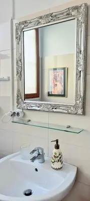 a bathroom with a sink and a mirror on the wall at L'Appart by la Maïoun Guesthouse in Nice