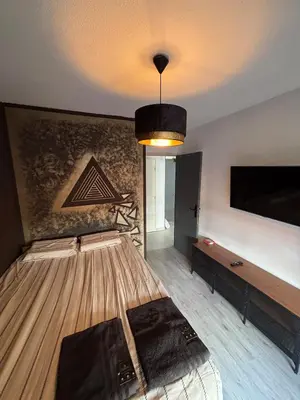 a room with a bed and a wall with a tv at Charmant 2 pièce à 2min de la mer in Nice