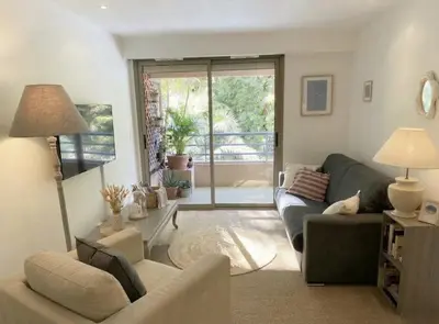 a living room with a couch and a tv at Studio with Terrace near Beach in Nice