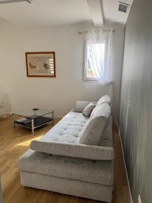 a living room with a couch and a table at Renovated luxury cocoon Place Masséna in Nice