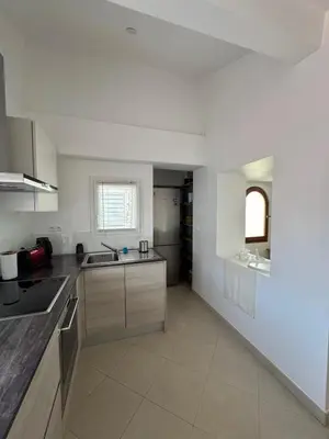 a kitchen with white walls and a counter top at Renovated luxury cocoon Place Masséna in Nice