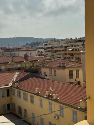 a view of a city with buildings and roofs at Renovated luxury cocoon Place Masséna in Nice
