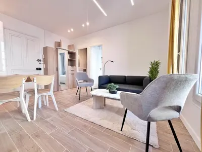 a living room with a couch and a table and chairs at RF 121 Close to port 2 bedrooms 2 toilets in Nice