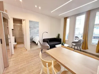 a living room with a table and chairs at RF 121 Close to port 2 bedrooms 2 toilets in Nice