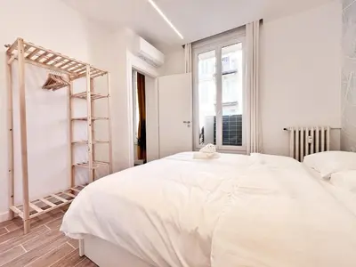 a white bedroom with a large bed and a window at RF 121 Close to port 2 bedrooms 2 toilets in Nice