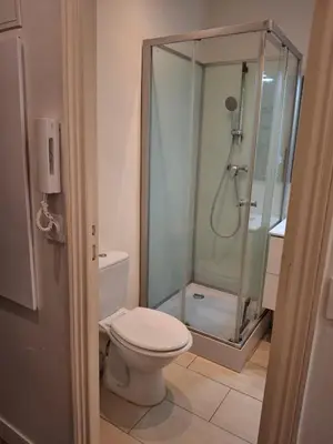 a bathroom with a toilet and a glass shower at Studio 1 pièce in Nice
