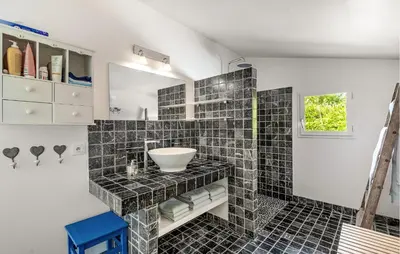a bathroom with black tiled walls and a sink at Beautiful Home In Eze in Èze