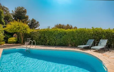a swimming pool with two chairs and a swimming pool at Beautiful Home In Eze in Èze