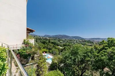 a view from the balcony of a house with trees at VILLA MONTE CRISTO - Villa conviviale a Nice - Superbe vue, piscine et jeux en plein air in Nice