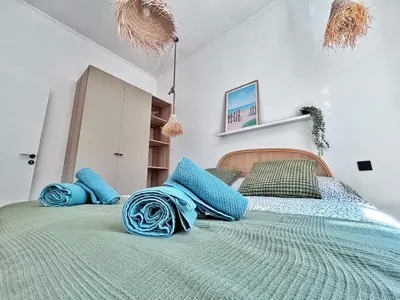 a bedroom with a large bed with blue pillows at Ref 118 Oliviera 2 Beds Apartment in Riquier in Nice
