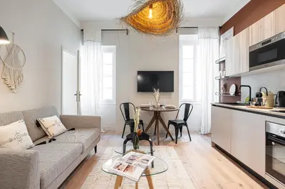 a living room with a couch and a table at 5 BEAUMONT - Magnifique 3P au style boheme - Quartier Garibaldi in Nice
