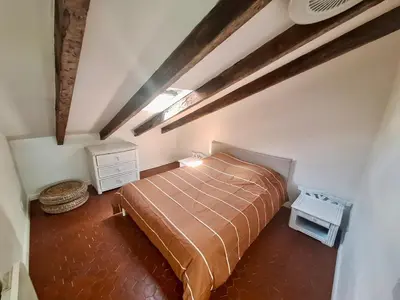an attic bedroom with a bed and a table at Lofty Hideout with 2 bedrooms in Nice